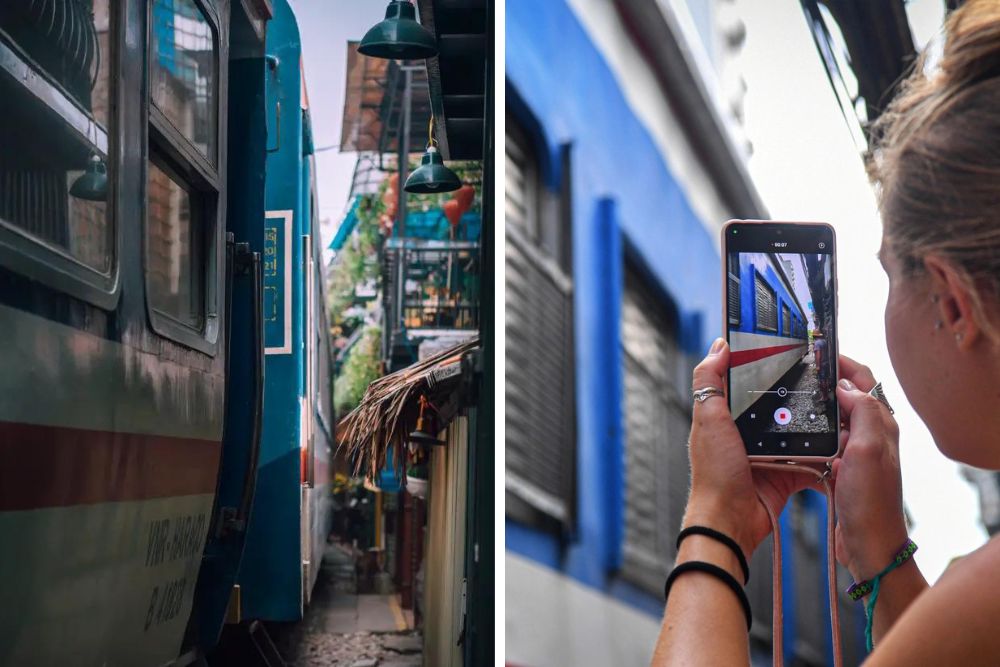 rue du train hanoi, touriste prend une photo du train qui passe très proche d'elle, voyage vietnam